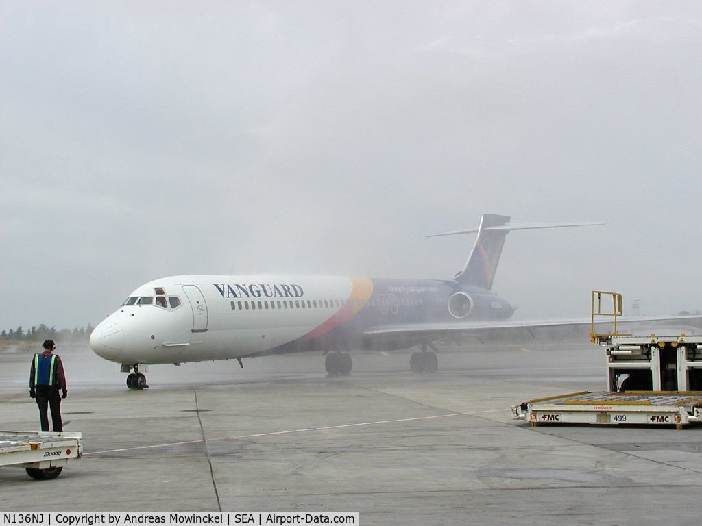 N136NJ, 1990 McDonnell Douglas DC-9-87 C/N 49413, Vanguard Airlines operated at SEA between June 3 and July 30, 2002. Photographer was the Station Manager. In picture an MD87 taxiing through the waterarch after the inaugural flight