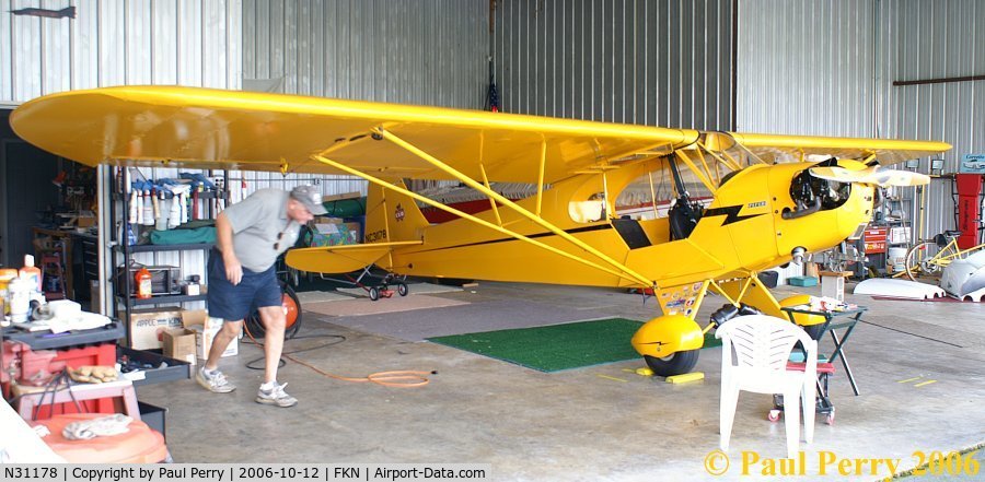 N31178, 1940 Piper J-3 Cub C/N 5388, Busy man there, ducking under his starboard wing