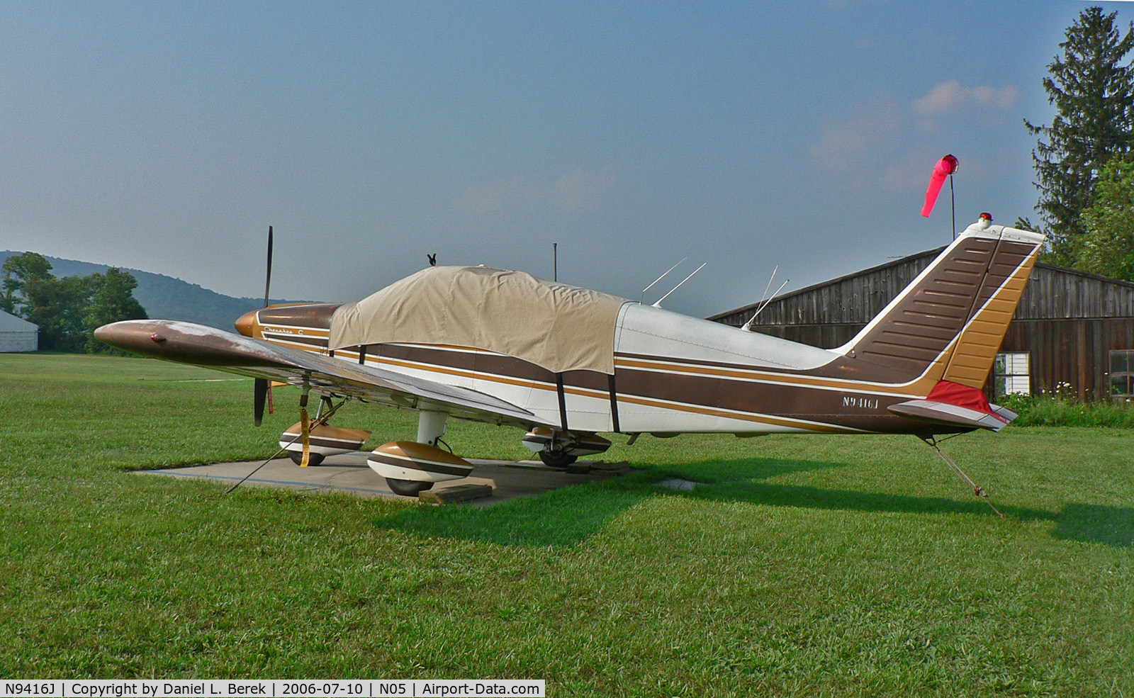 N9416J, 1966 Piper PA-28-180 C/N 28-3526, Faded but well cared-for 1966 Chrokee Archer takes refuge from the summer sun.