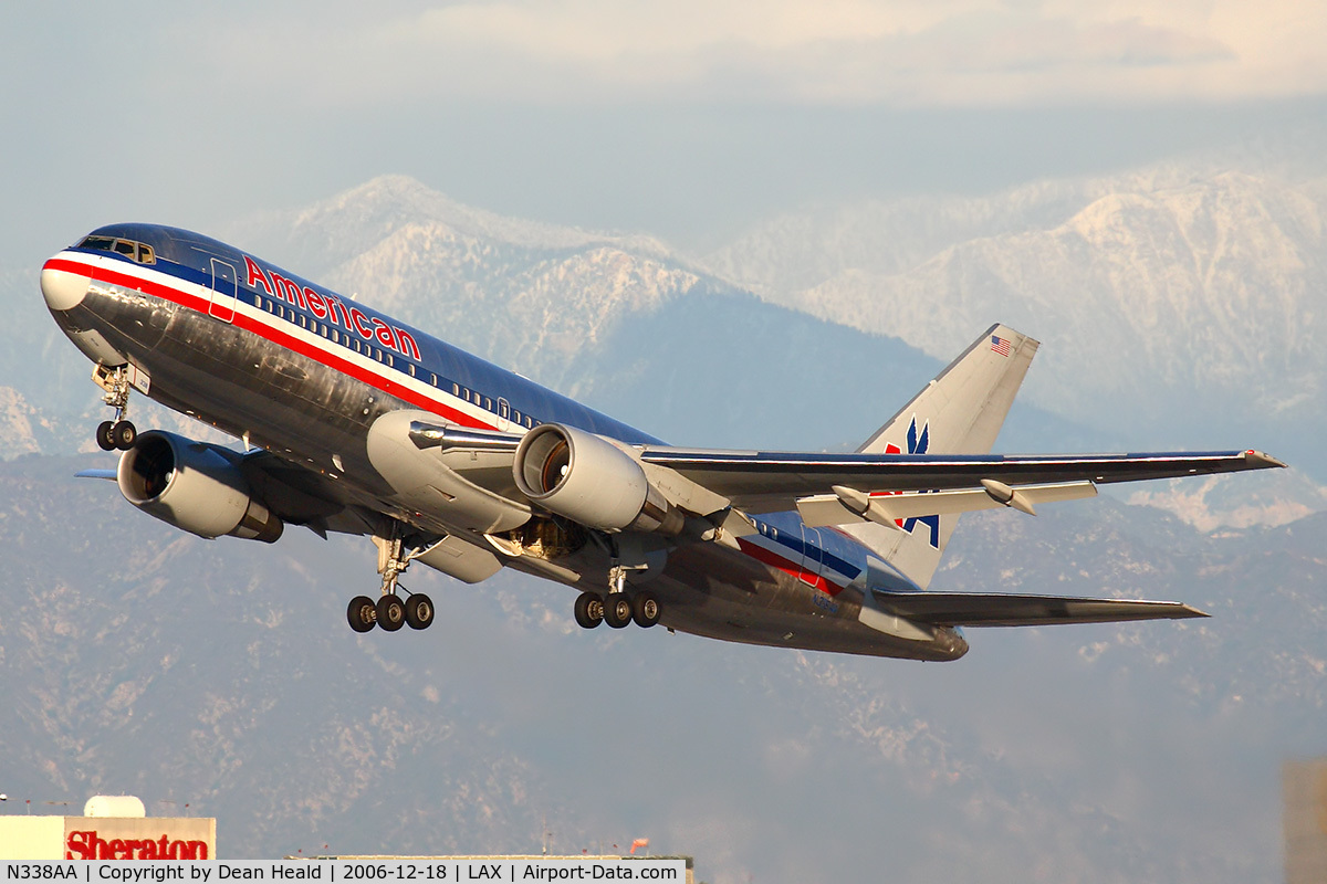 N338AA, 1987 Boeing 767-223 C/N 22335, American Airlines N338AA (FLT AAL22) climbing out from RWY 25R enroute to Dallas Fort Worth Int'l (KDFW) with the snow-capped San Gabriel Mountains in the background.