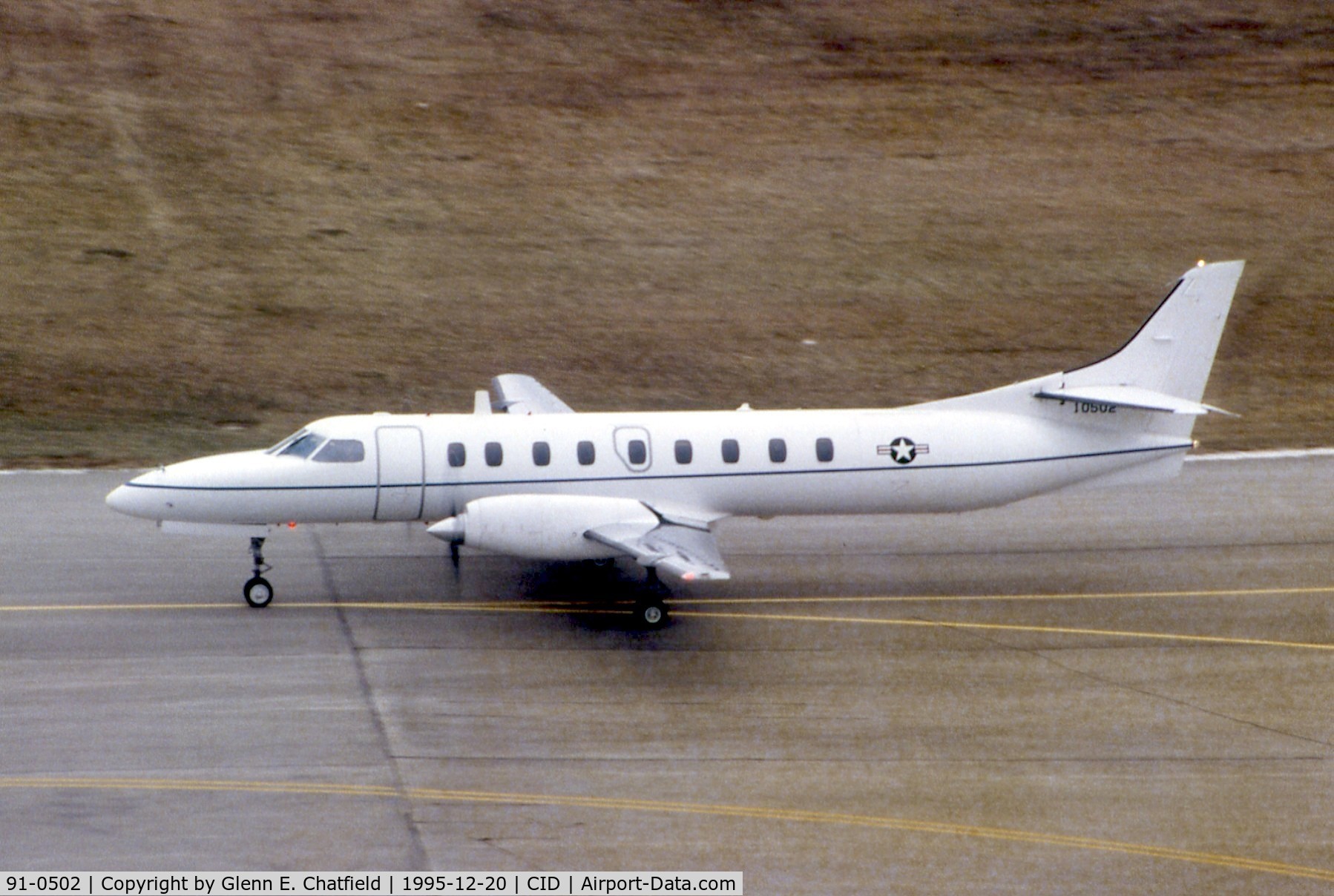 91-0502, 1990 Fairchild Swearingen C-26D Metro III C/N DC-801M, C-26D taxiing past the control tower.  Hot film left brown haze