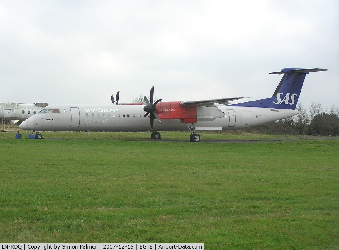 LN-RDQ, 1999 De Havilland Canada DHC-8-402Q Dash 8 C/N 4008, DHC-8-400 in the storage area at Exeter