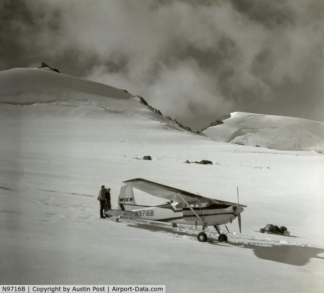 N9716B, 1957 Cessna 180A C/N 50014, unloads people and supplies in the upper cirque of McCall Glacier, with the IGY camp in the background