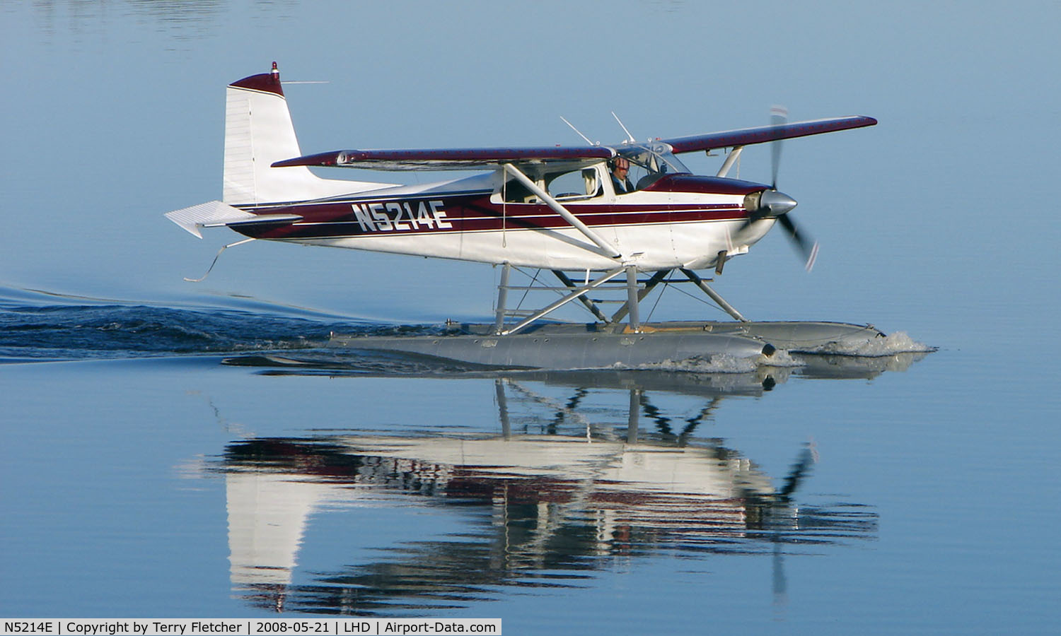 N5214E, 1959 Cessna 180B C/N 50514, A beautiful mirror image as this Cessna 180B makes an early morning departure from Lake Hood