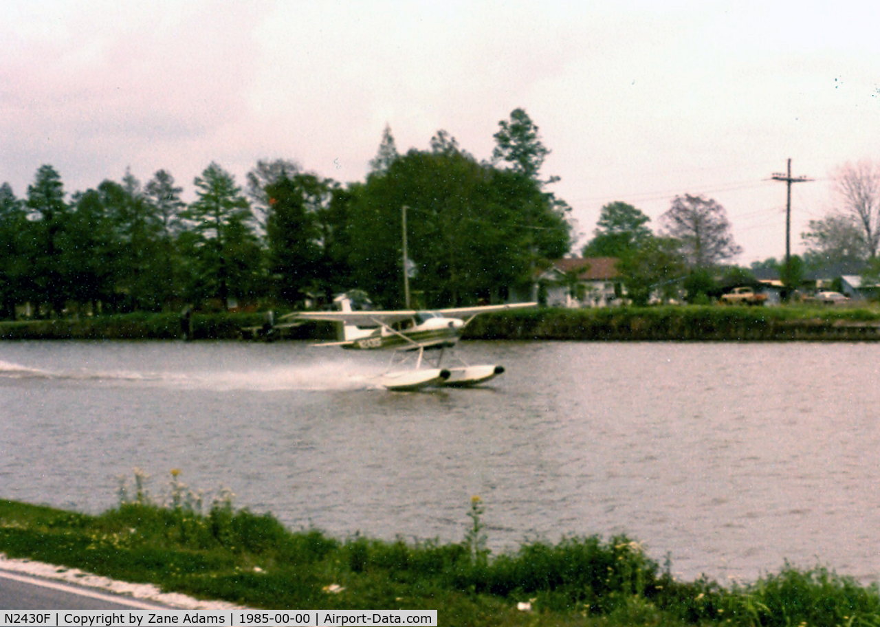 N2430F, 1965 Cessna 180H Skywagon C/N 18051630, Taking off in Bayou Lafourche Cut Off, LA