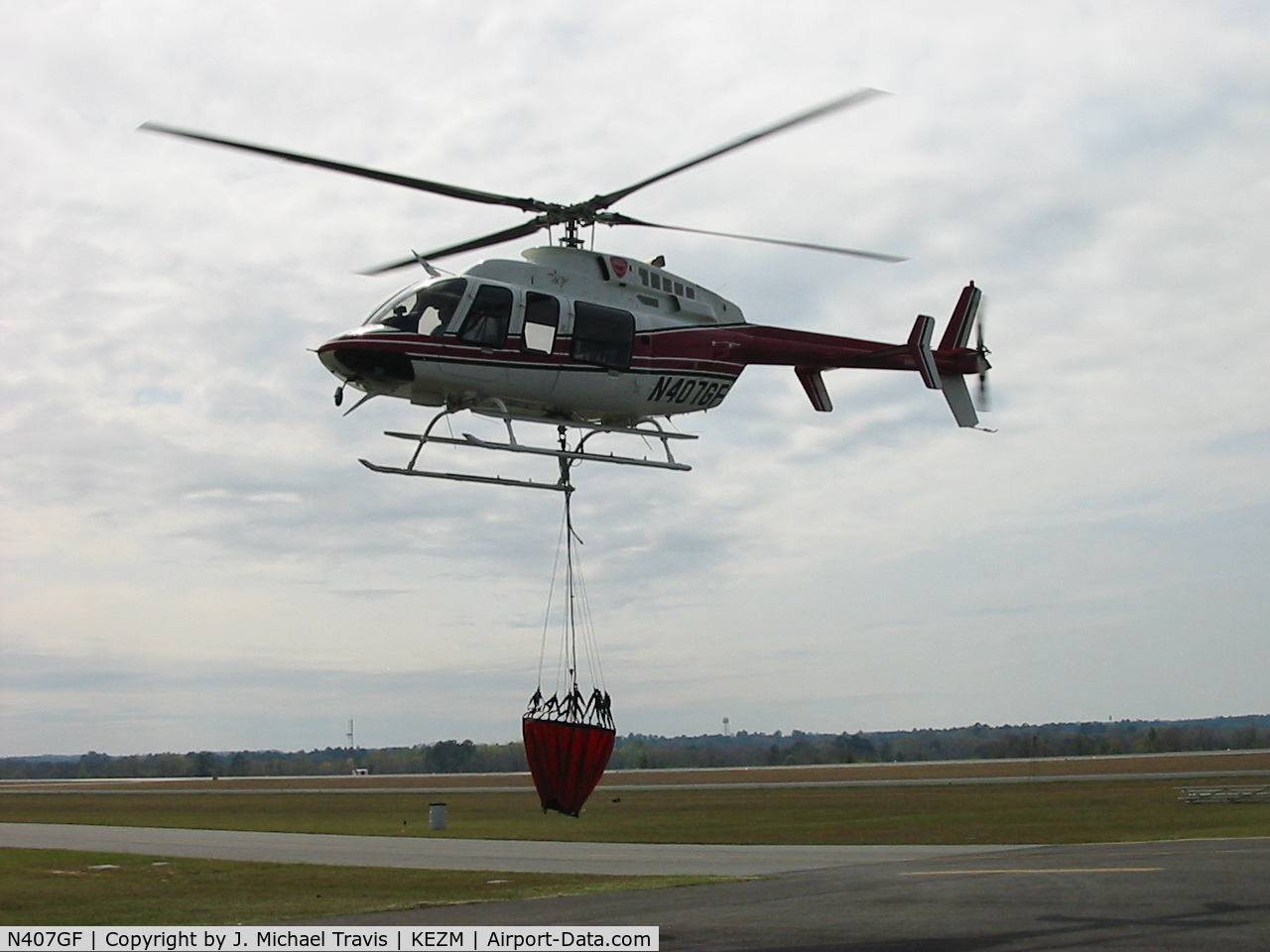 N407GF, 2000 Bell 407 C/N 53452, Forestry Service Bell 407 landing for fuel after a water drop.