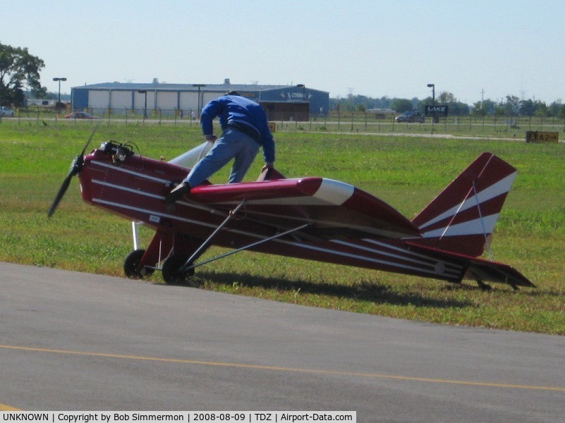 UNKNOWN, , After starting the Rotax engine with a pull rope, the pilot boards the aircraft over the front of the wing.  EAA breakfast fly-in at Toledo, OH.