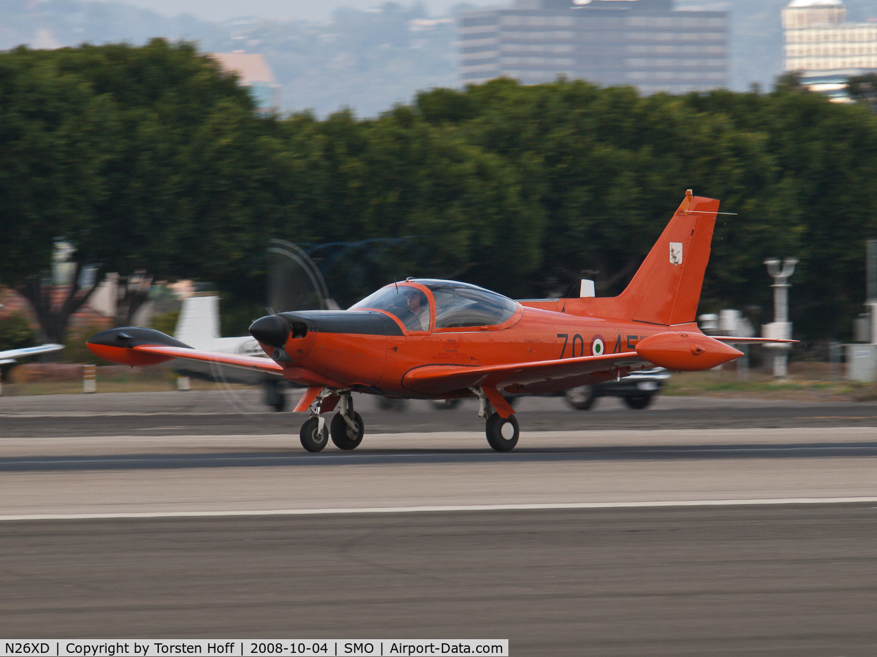 N26XD, 1987 SIAI-Marchetti F-260C C/N 40-016, N26XD departing on RWY 21. Note faint vapor compression vortices forming on propeller tips.
