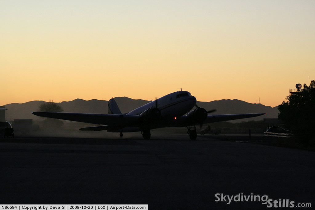 N86584, 1942 Douglas DC-3-G202A C/N 4935, DC-3 taxies in at sunset.