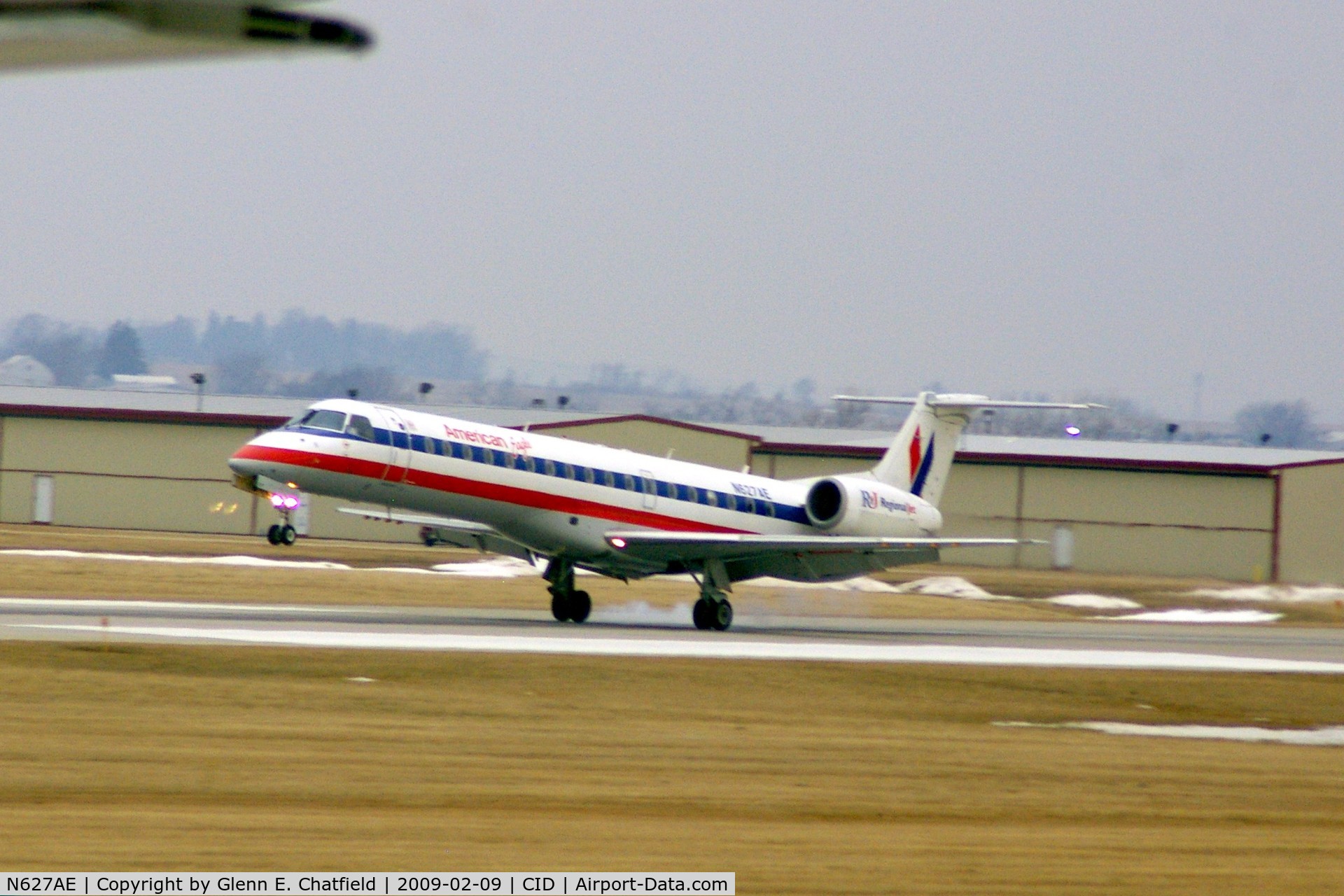 N627AE, 1999 Embraer ERJ-145LR (EMB-145LR) C/N 145121, Touching down on runway 13.  Hazy, and a wee bit blurred shot