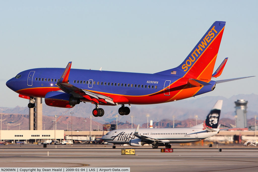 N290WN, 2007 Boeing 737-7H4 C/N 36632, Southwest Airlines N290WN (FLT SWA2590) from Los Angeles Int'l (KLAX) landing on RWY 1L while Alaska Airlines N570AS is starting takeoff roll on RWY 1R.