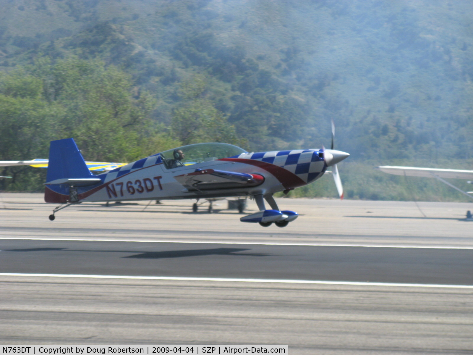 N763DT, 2007 Extra EA-300/L C/N 1258, 2007 Extra Flugzeugproduktions EXTRA EA 300L, Lycoming AEIO-540-L1B5 300 Hp, takeoff climb Rwy 22 through dissipating airshow smoke from N64SH