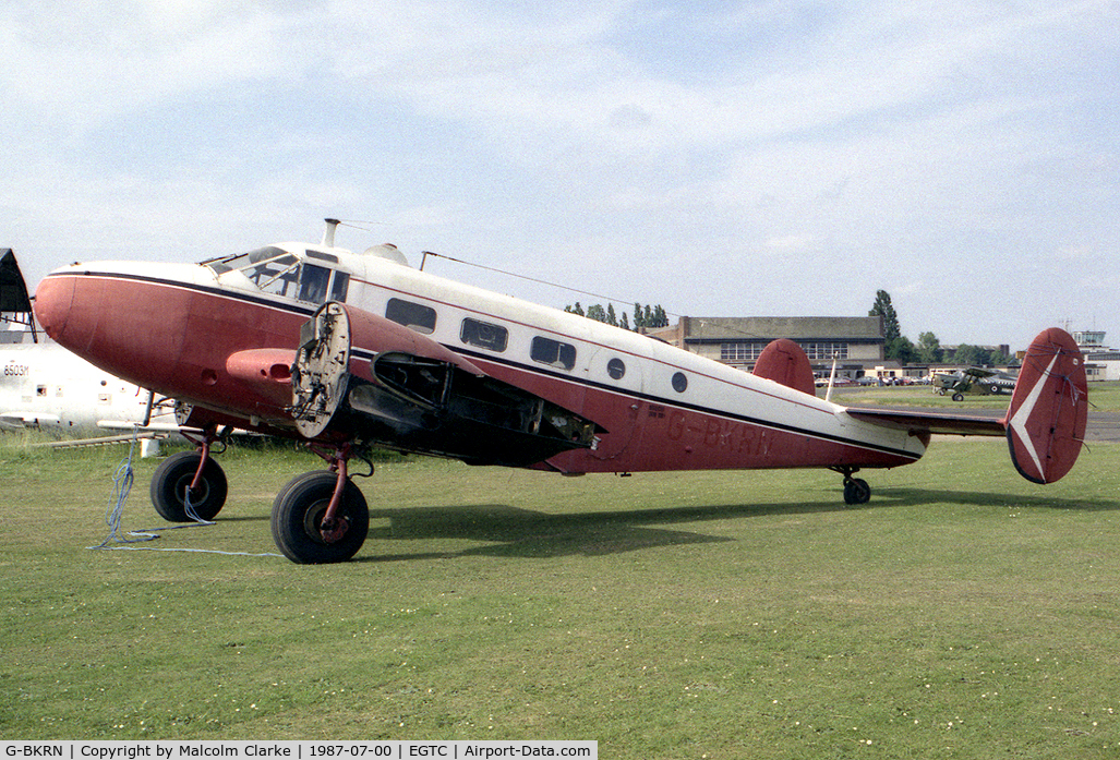 G-BKRN, 1952 Beech D18S C/N CA-75, Beech D18S. At the time this photograph was taken, in 1987, it was in the hands of the Vintage Aircraft Team at Cranfield who preserved it in the condition shown until it was purchased in 1996 for restoration to flying condition by Beech Restorations.