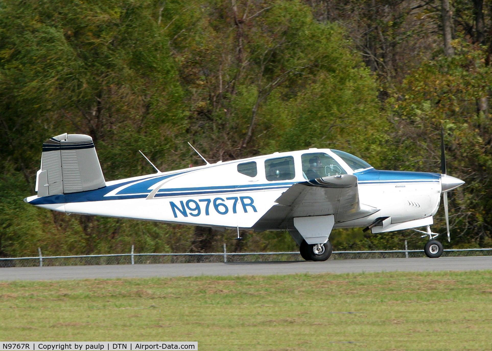 N9767R, 1959 Beech M35 Bonanza C/N D-6254, Rolling for take off at Downtown Shreveport.