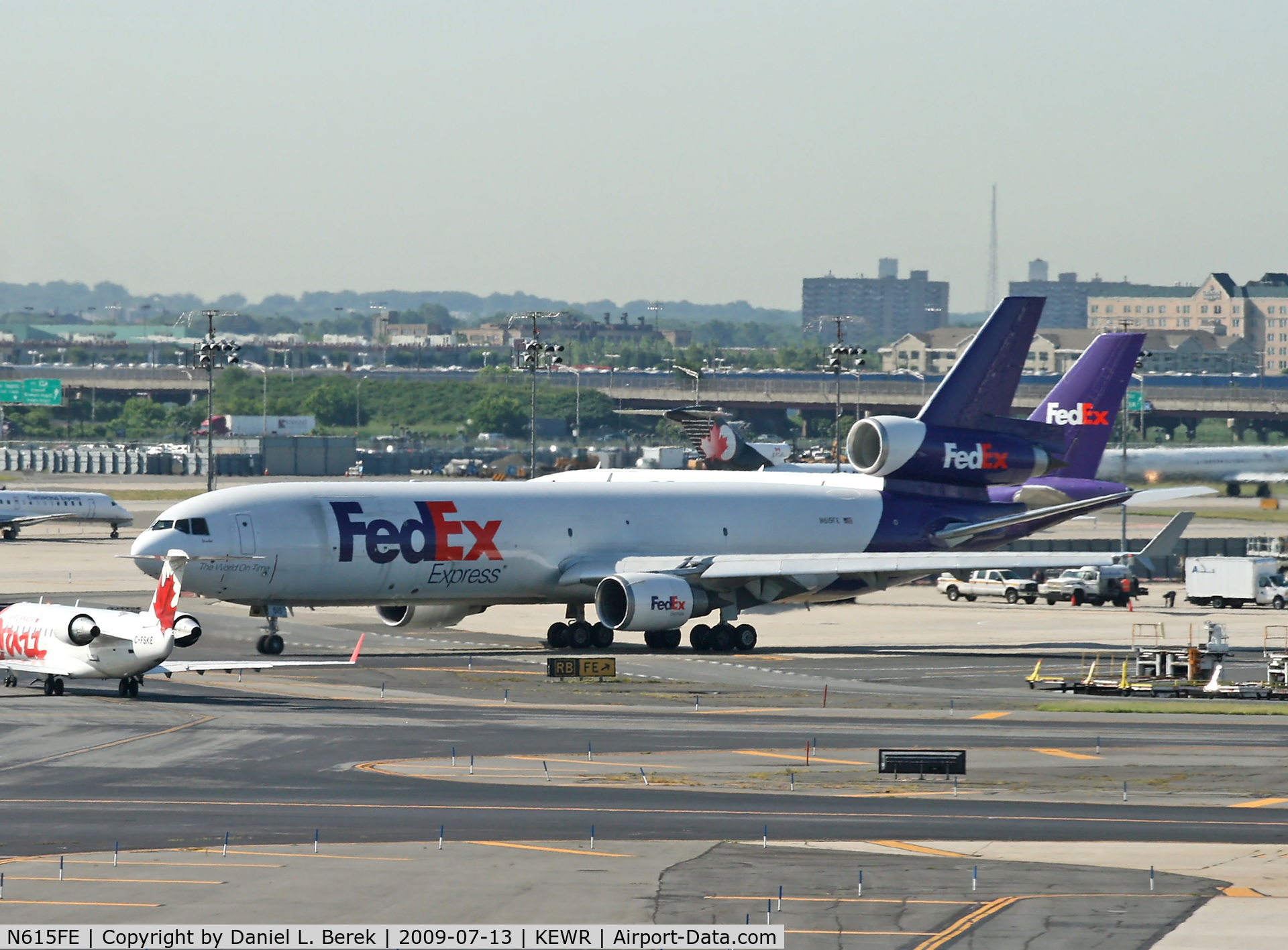 N615FE, 1996 McDonnell Douglas MD-11F C/N 48767, A FedEx freighter navigates the crowded ramp at Newark on a hot July morning in 2009.