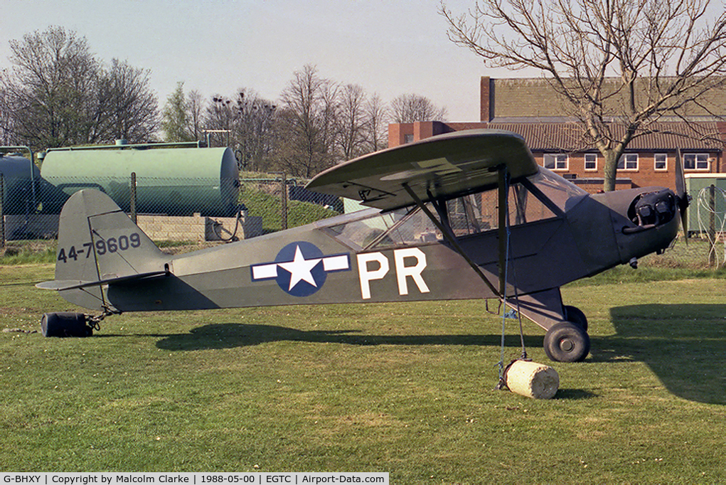 G-BHXY, 1944 Piper L-4H Grasshopper (J3C-65D) C/N 11905, Piper L-4H Grasshopper as USAF 44-79609. At Cranfield Airfield in 1988.