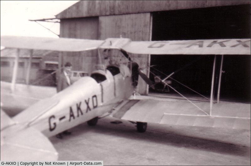 G-AKXO, 1940 De Havilland DH-82A Tiger Moth II C/N 83548, This is G-AKXO when it was in use as a trainer at Sherburn in Elmet in Yorkshire, in 1956.  My eldest brother (indistinct picture behind) qualified in this Tiger Moth before he died as a result of a rugby accident later that year.  Sorry about the poor qu