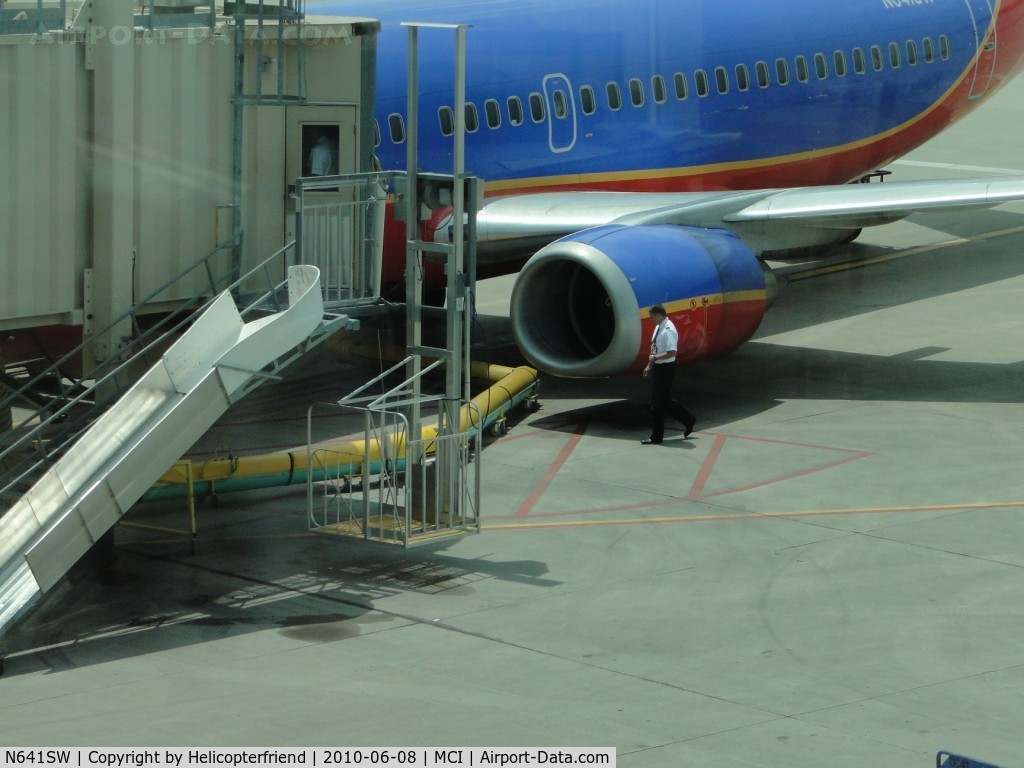 N641SW, 1996 Boeing 737-3H4 C/N 27714, A member of the Flight Crew doing a walk around inspection of the aircraft