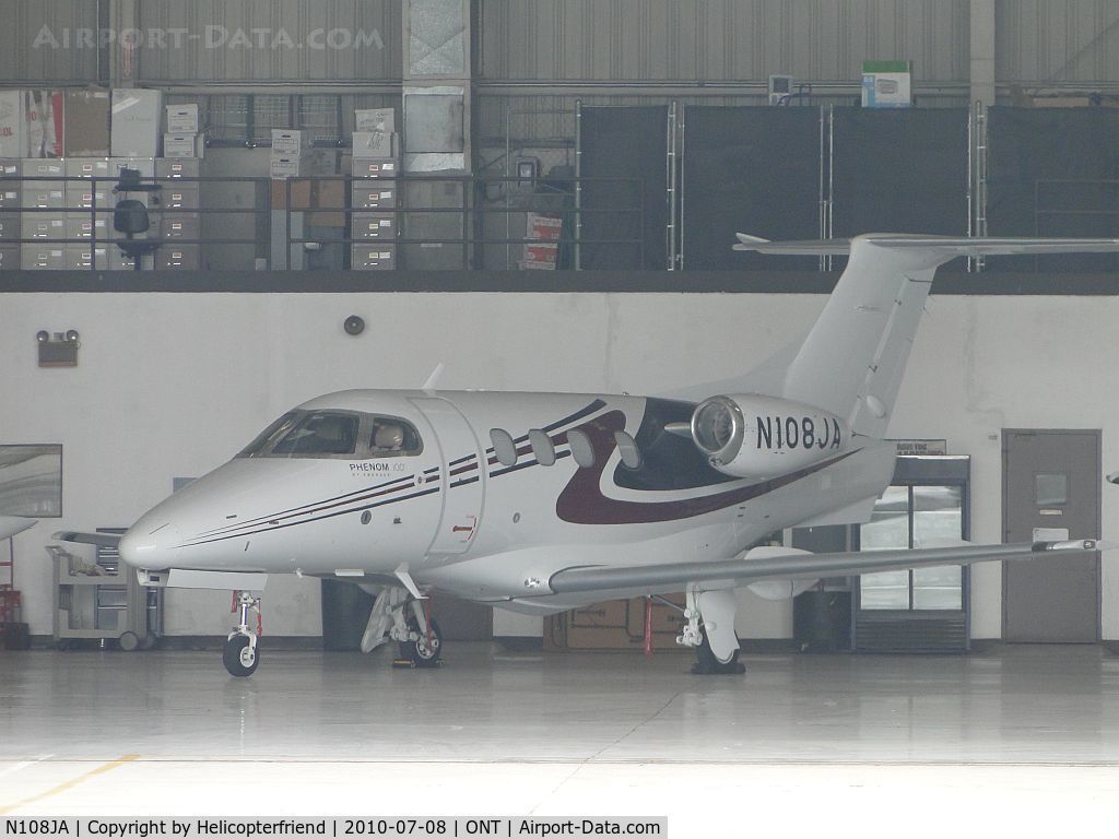 N108JA, 2009 Embraer EMB-500 Phenom 100 C/N 50000023, Parked in the hanger on a gloomy morning