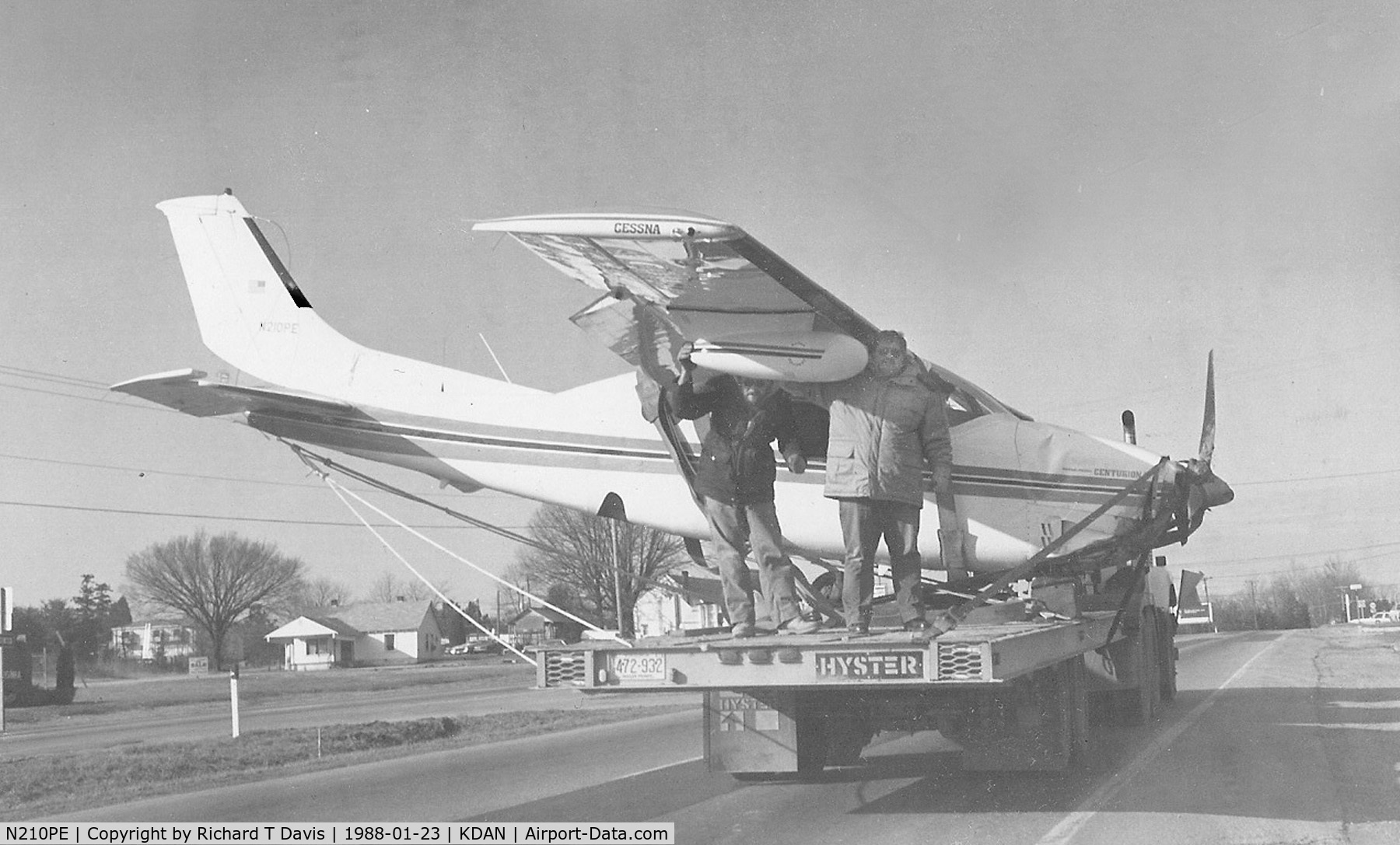 N210PE, 1969 Cessna 210J Centurion C/N 21059180, N210PE 1969 Cesna 210PE moves along on a trailer on 58 East back to KDAN ...it had crashed Jan. 21,1988 about 2 miles from the airport after it ran out of fuel..NTSB  BFO88LA015...thats Mike Rembold of General Aviation at right on the back...
