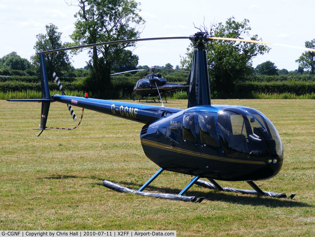 G-CGNF, 2010 Robinson R44 Clipper II C/N 13027, Robinson R44 being used for ferrying race fans to Silverstone for the British Grand Prix from this temporary heliport a few miles east of Bicester