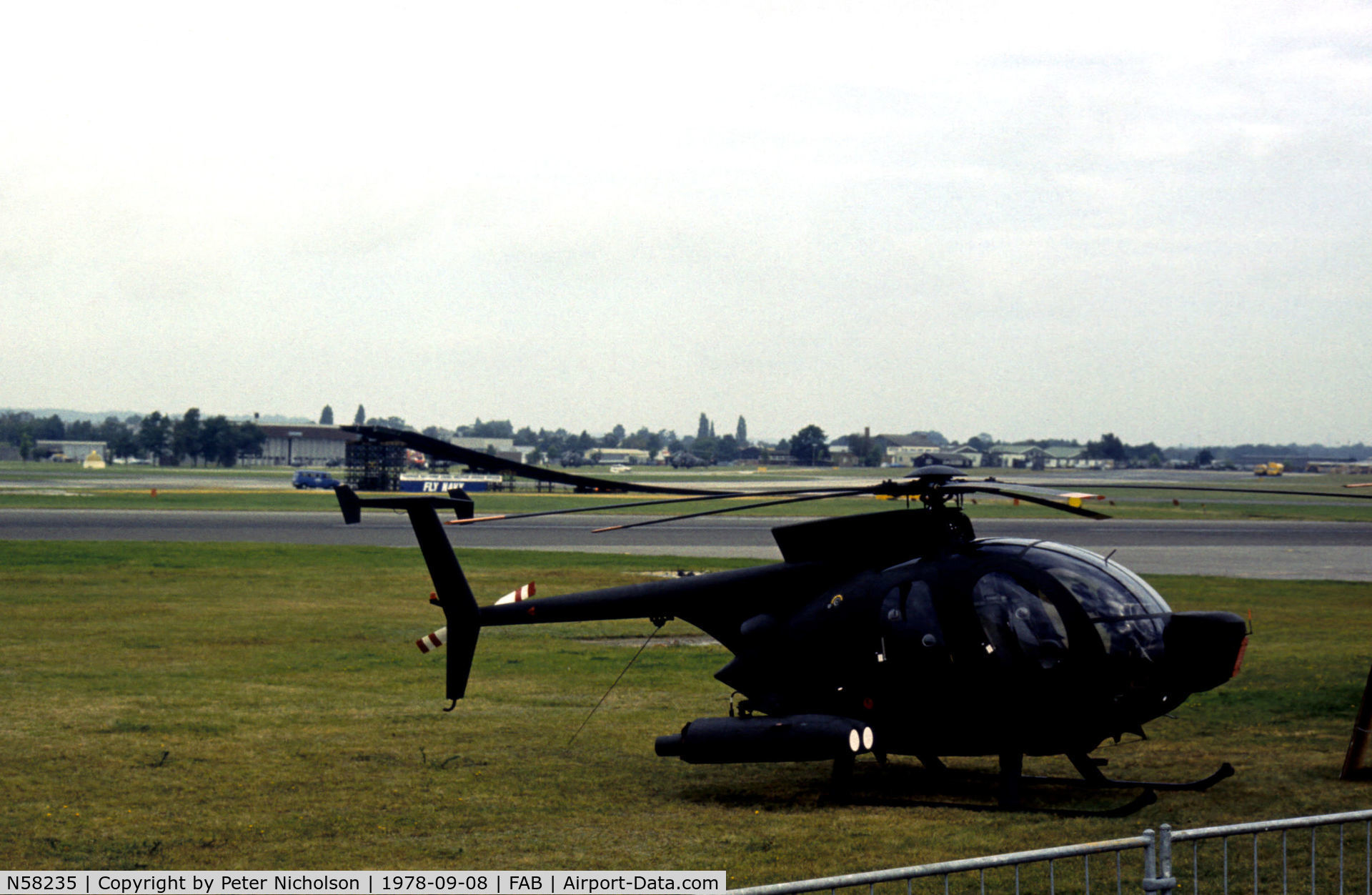 N58235, Hughes 500MD Defender (369MD) C/N 75-0323D, Hughes 500MD Defender on the flight-line at the 1978 SBAC Farnborough Airshow.