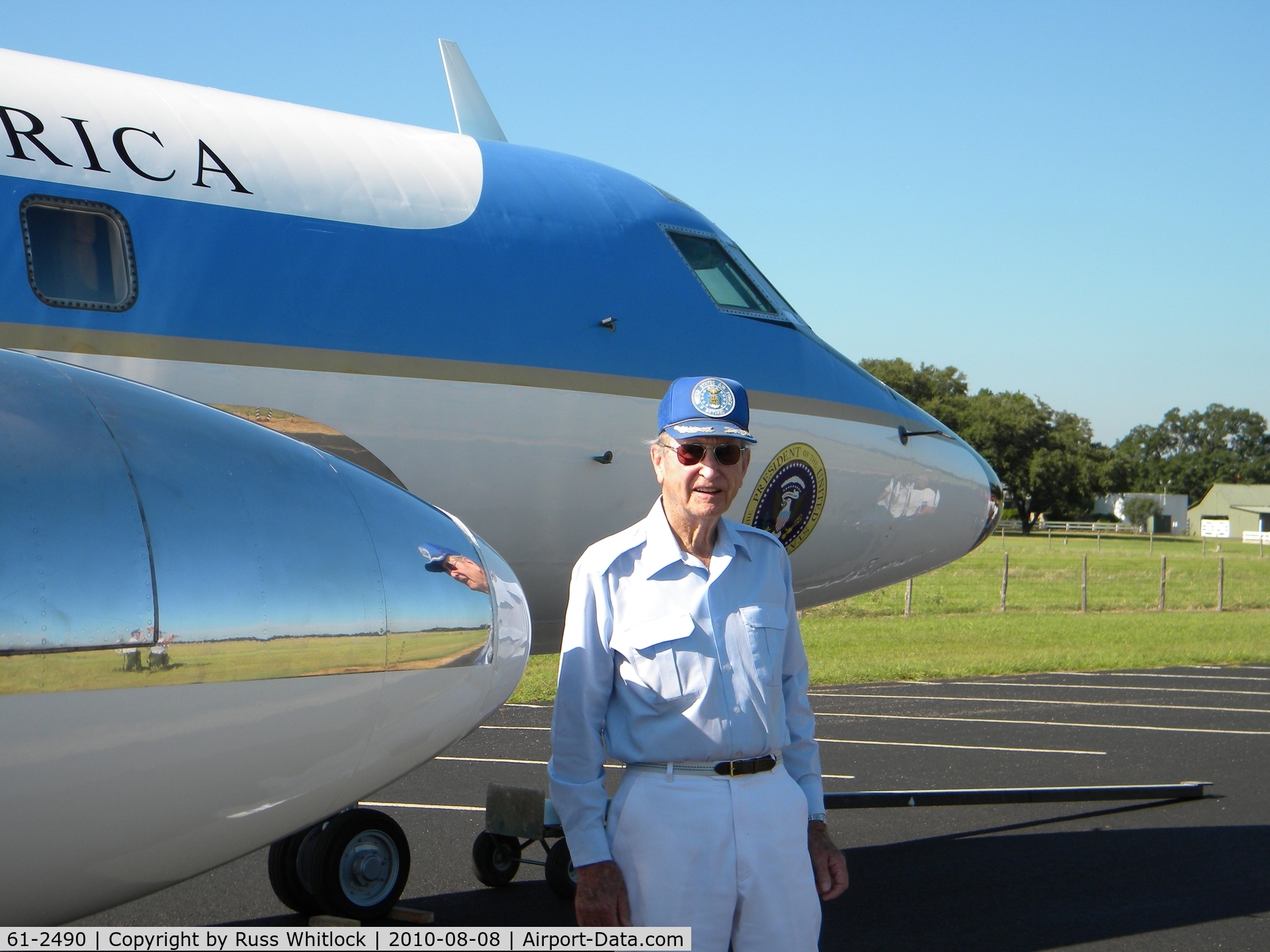 61-2490, 1962 Lockheed VC-140B-LM Jetstar C/N 1329-5024, Brig. General James U. Cross (retired) stands with one of the JetStar he piloted for President Johnson.  The photo was made on the LBJ Ranch taxiway with Texas White House in background.