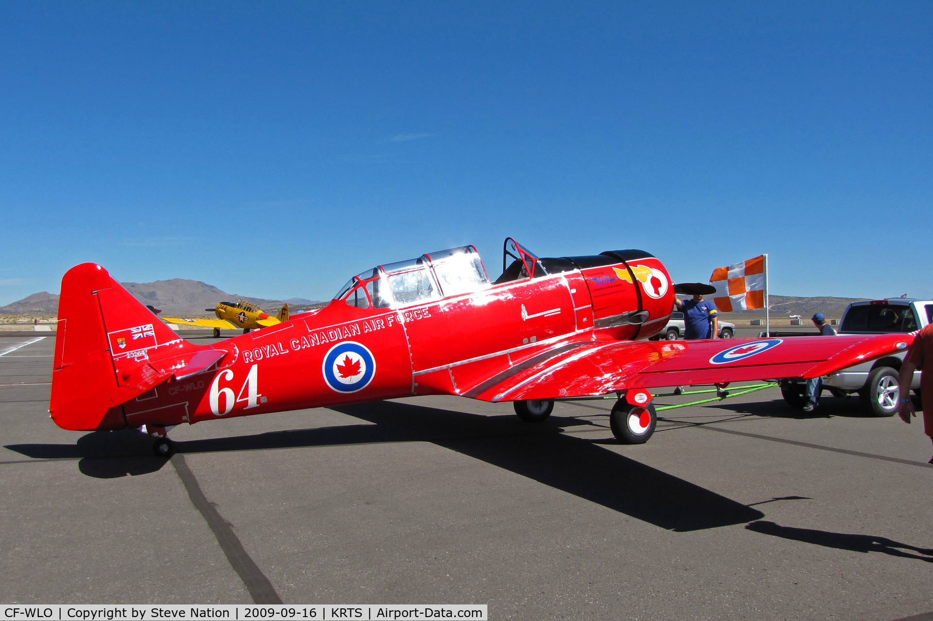 CF-WLO, 1945 Canadian Car & Foundry T-6 Harvard Mk.4 C/N CCF4-55, Race #64 is a CCF Harvard Mk. IV in Royal Canadian Air Force Red Knights colors being towed to active ramp for T-6 Class racing @ 2009 Reno Air Races