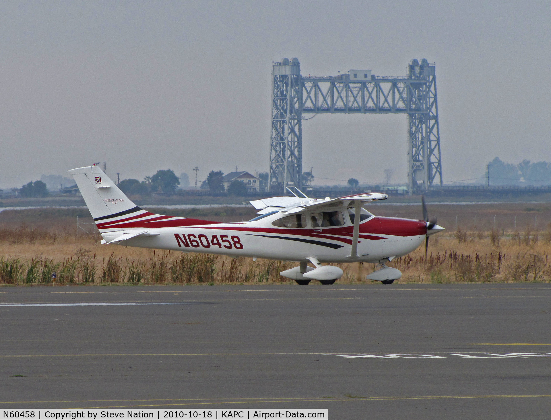 N60458, 2006 Cessna T182T Turbo Skylane C/N T18208574, 2006 Cessna T182T taxis past Napa River RR Bridge for flight home to KMYF (Montgomery Field/San Diego, CA)