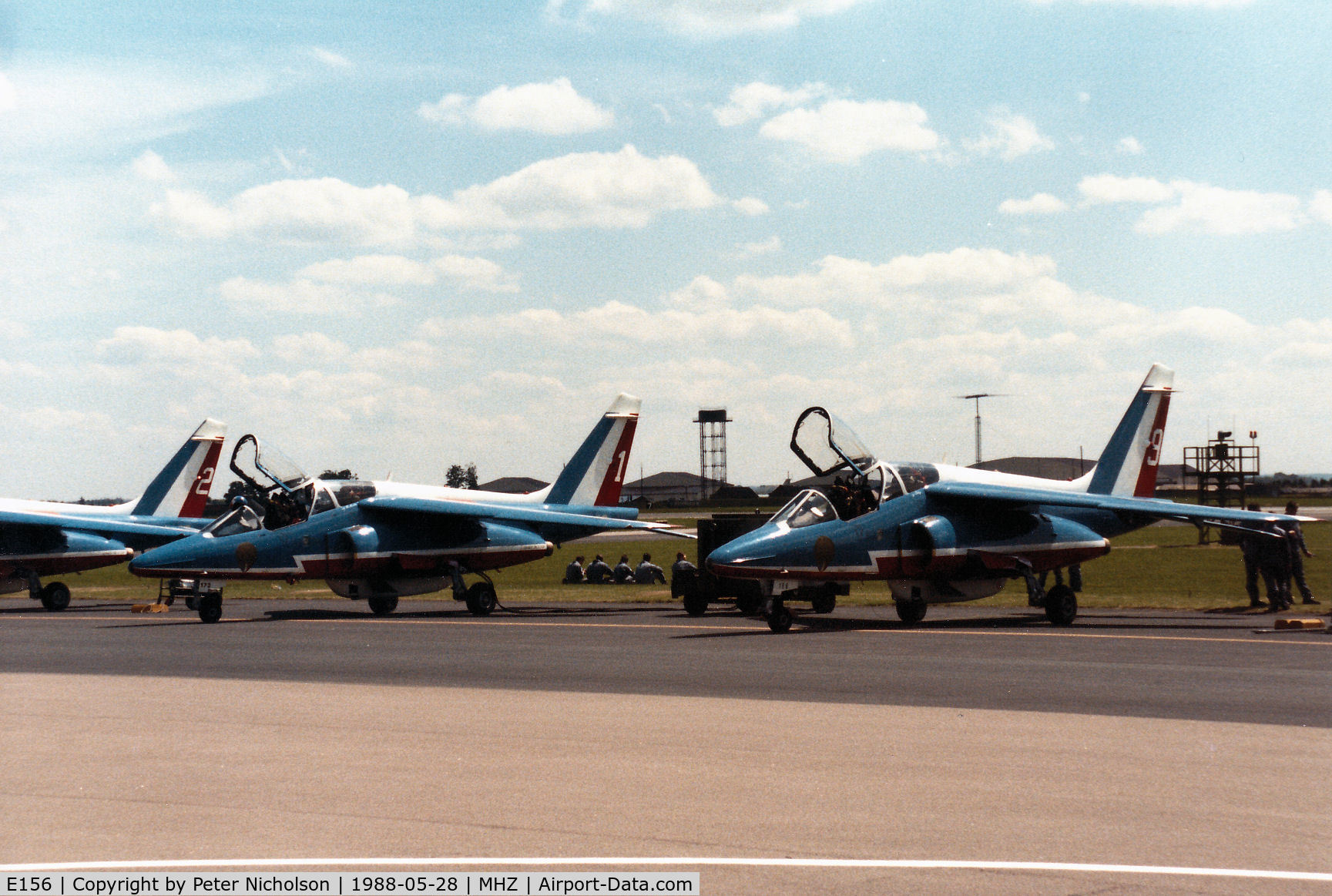 E156, Dassault-Dornier Alpha Jet E C/N E156, Alpha Jet number 9 of the Patrouille de France aerobatic display team, alongside E173 number 1, on the flight-line at the 1988 RAF Mildenhall Air Fete.