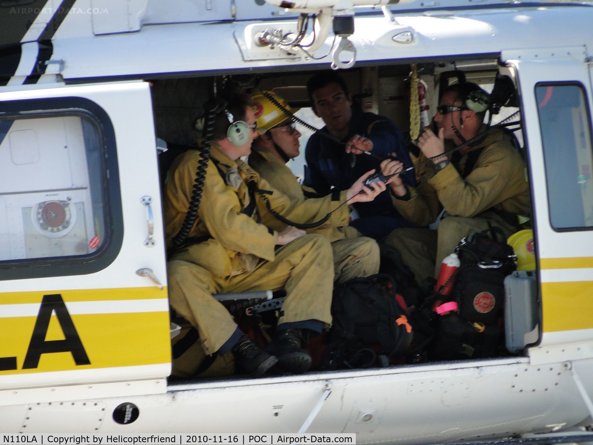 N110LA, 2005 Bell 412EP C/N 36392, Helicopter crew member showing firefighters how to use the radio