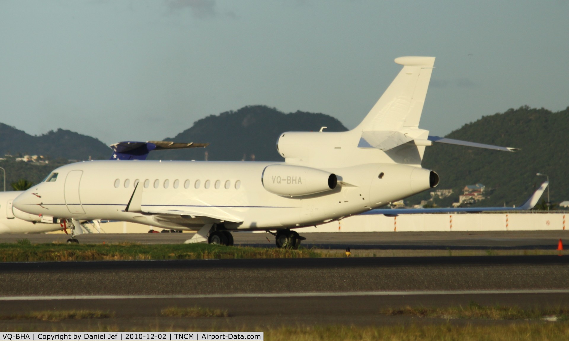 VQ-BHA, 2009 Dassault Falcon 7X C/N 84, VQ-BHA park on the ramp next to the fuel station and the blass wall at TNCM.