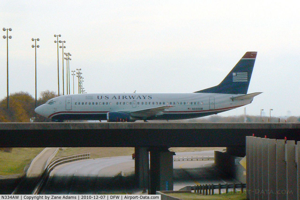 N334AW, 1987 Boeing 737-3Y0 C/N 23748, US Air crossing the south bridge at DFW Airport - TX
(taken through the windshield on the service road :)