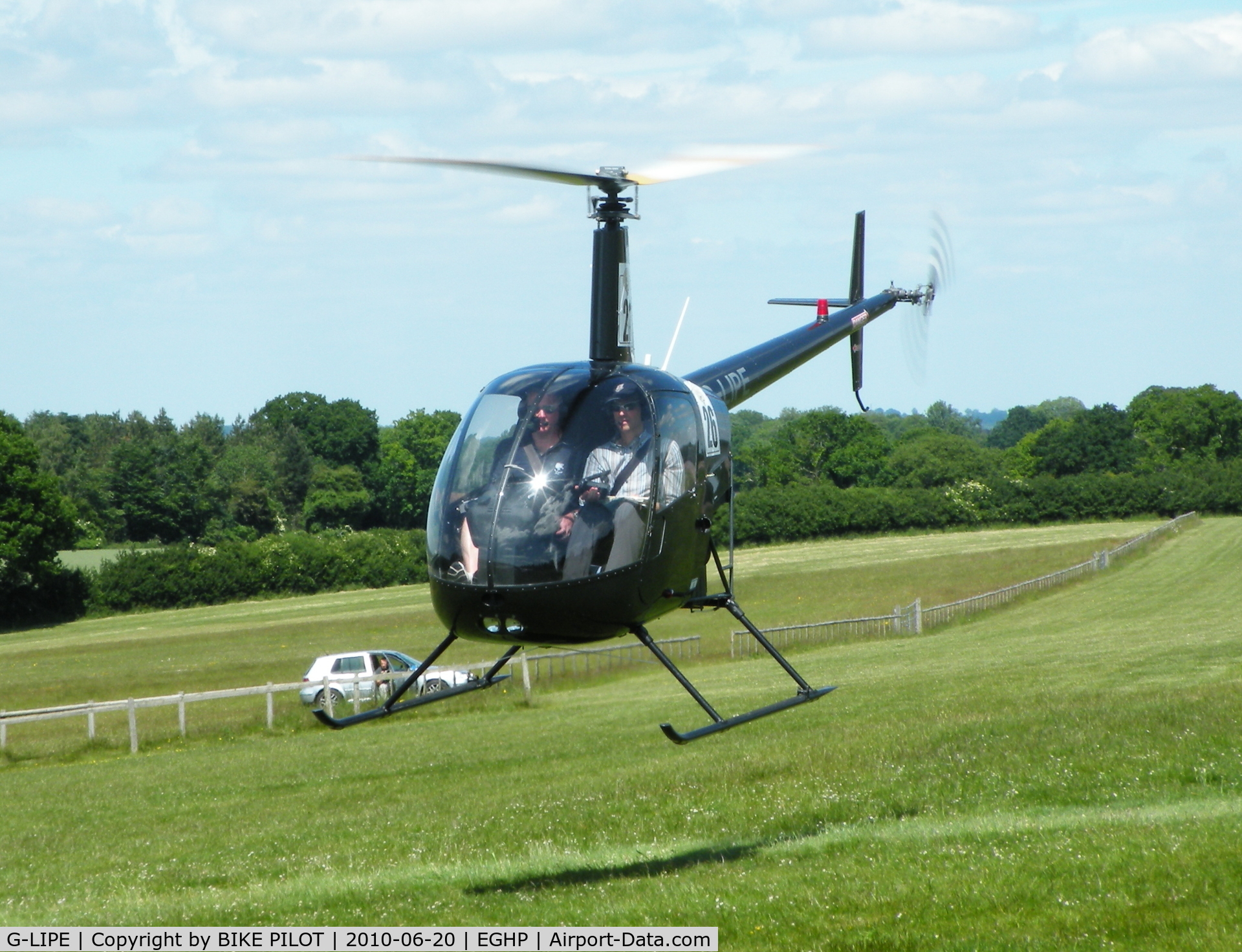 G-LIPE, 1991 Robinson R22 Beta C/N 1882, Papa Echo with competition numbers manouvering to land