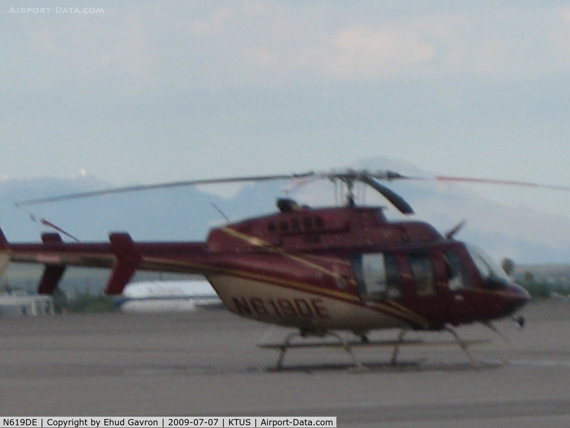 N619DE, 2000 Bell 407 C/N 53410, Helicopter hovering over the helipad at base of the tower, KTUS