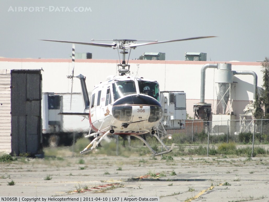 N306SB, Bell UH-1H Iroquois C/N 13041 (71-20217), Appear to be checking out photographer, but believe they were checking for incoming aircraft