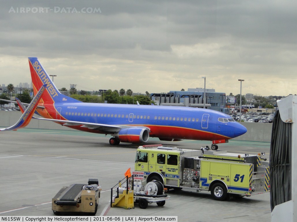 N615SW, 1995 Boeing 737-3H4 C/N 27698, Stopped before turning into terminal 3 to wait for fire truck to pass