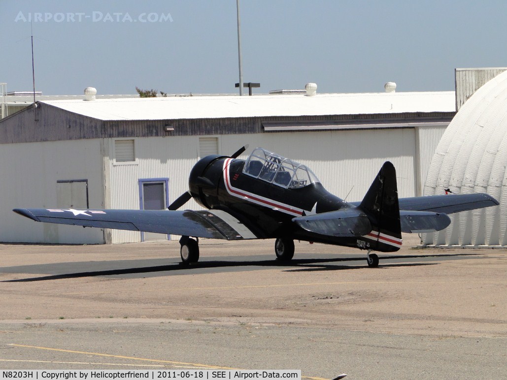 N8203H, 1960 North American T-6G Texan C/N 168-345, Parked on the south side by a hanger