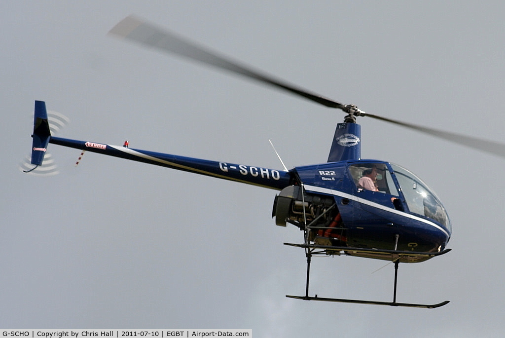 G-SCHO, 2005 Robinson R22 Beta II C/N 3833, being used for ferrying race fans to the British F1 Grand Prix at Silverstone
