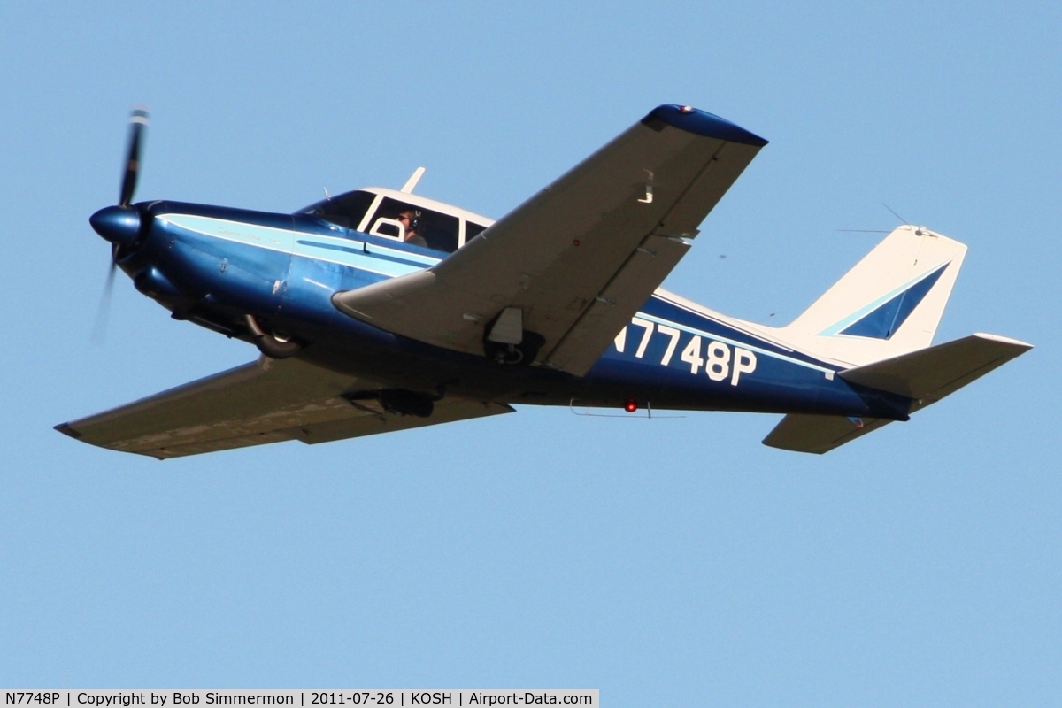 N7748P, 1961 Piper PA-24-250 Comanche C/N 24-2963, Departing Airventure 2011.