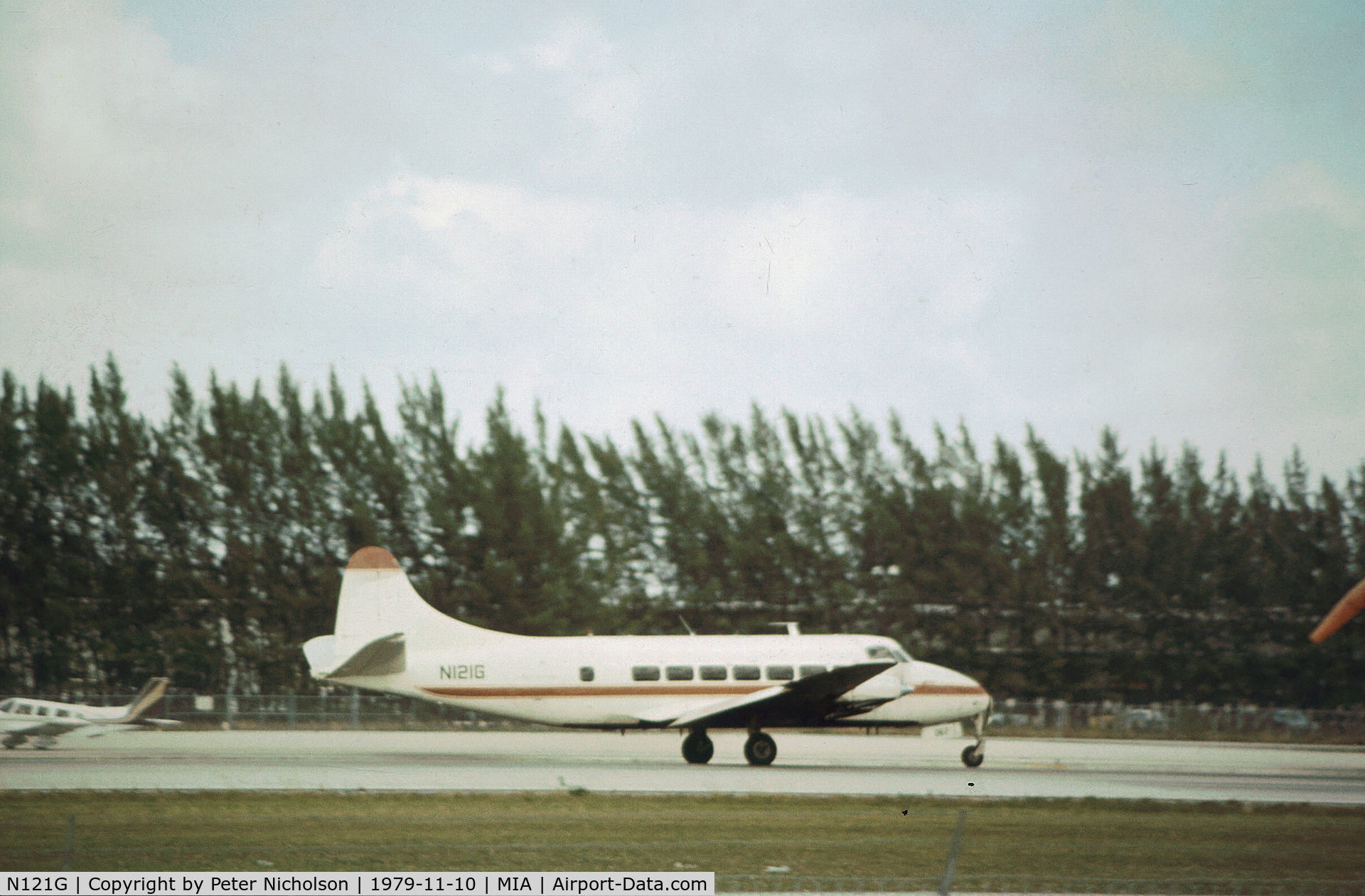 N121G, 1954 De Havilland DH-114 Heron 2X C/N 14063, Riley Heron of Shawnee Airlines taxying at Miami in November 1979.