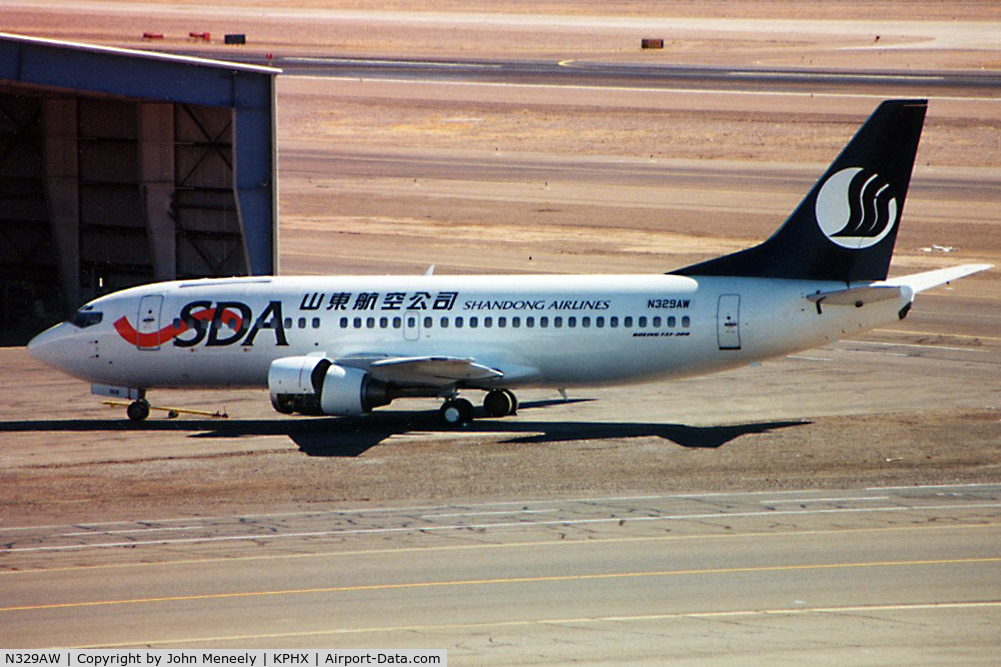 N329AW, 1986 Boeing 737-3Y0/SF C/N 23500, Being prepared for lease to Shandong Airlines of China. Taken in 2001 - scanned from a print.