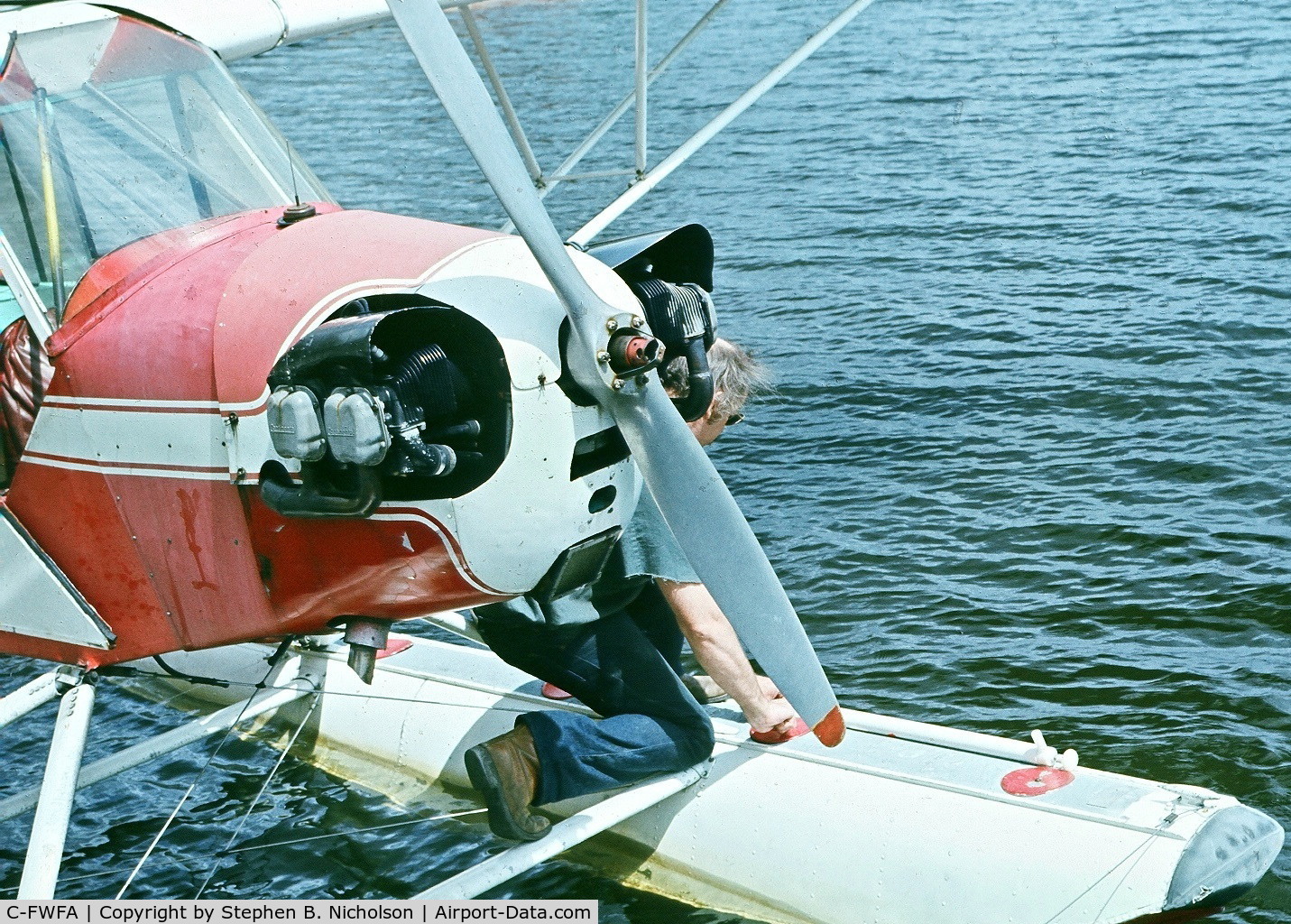 C-FWFA, 1946 Piper J3C-65 Cub Cub C/N 21265, Boots Milling pumping floats at Hooker seabase, Sioux Lookout, Ont circa 1977.