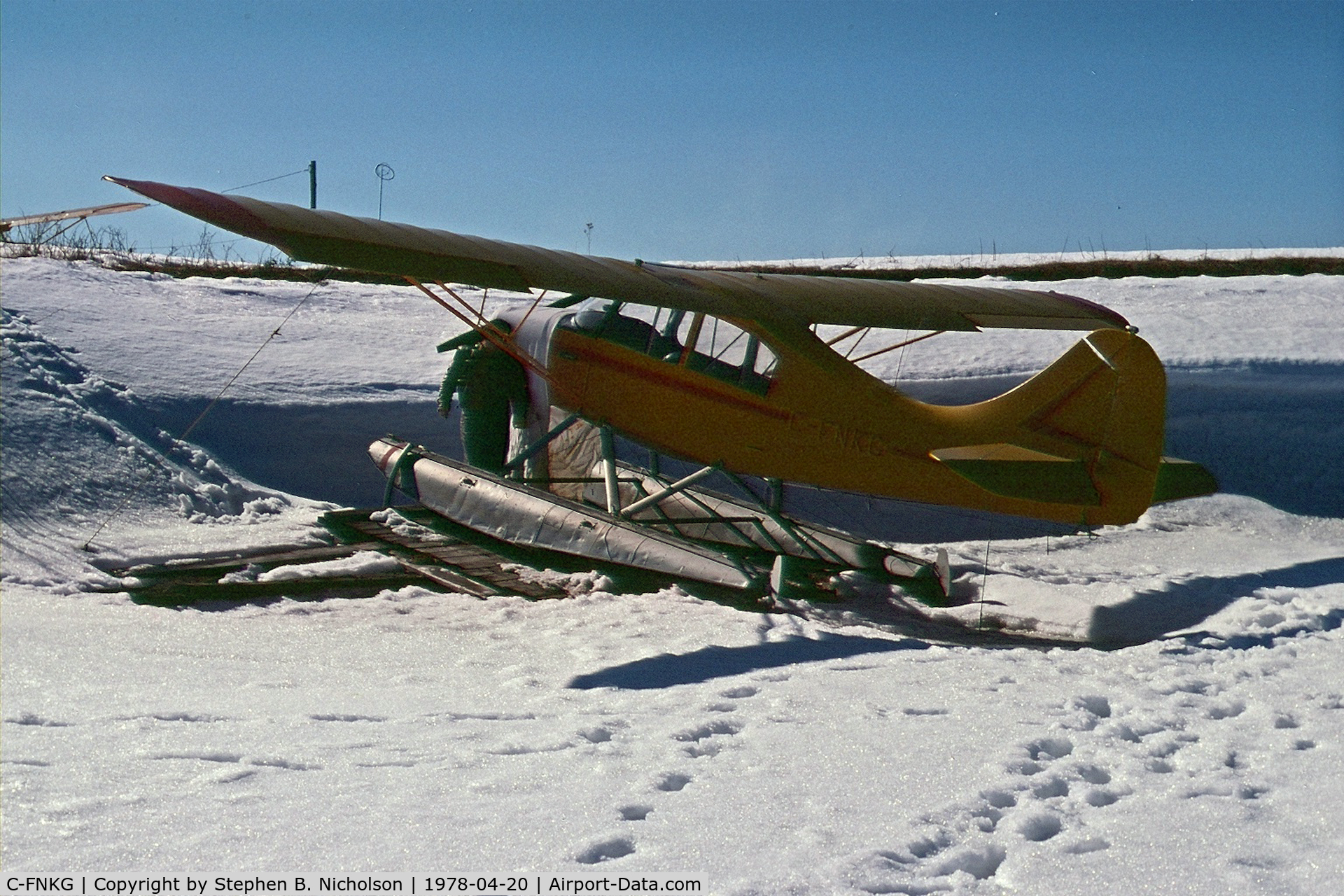 C-FNKG, 1955 Champion 7EC C/N 7EC 305, Seen in Dryden, Ontario pulled up on the shore of Wabigoon Lake on April 20, 1978. The photographer and Paul Boles were investigating its possible purchase for the Sioux Lookout Flying Club.