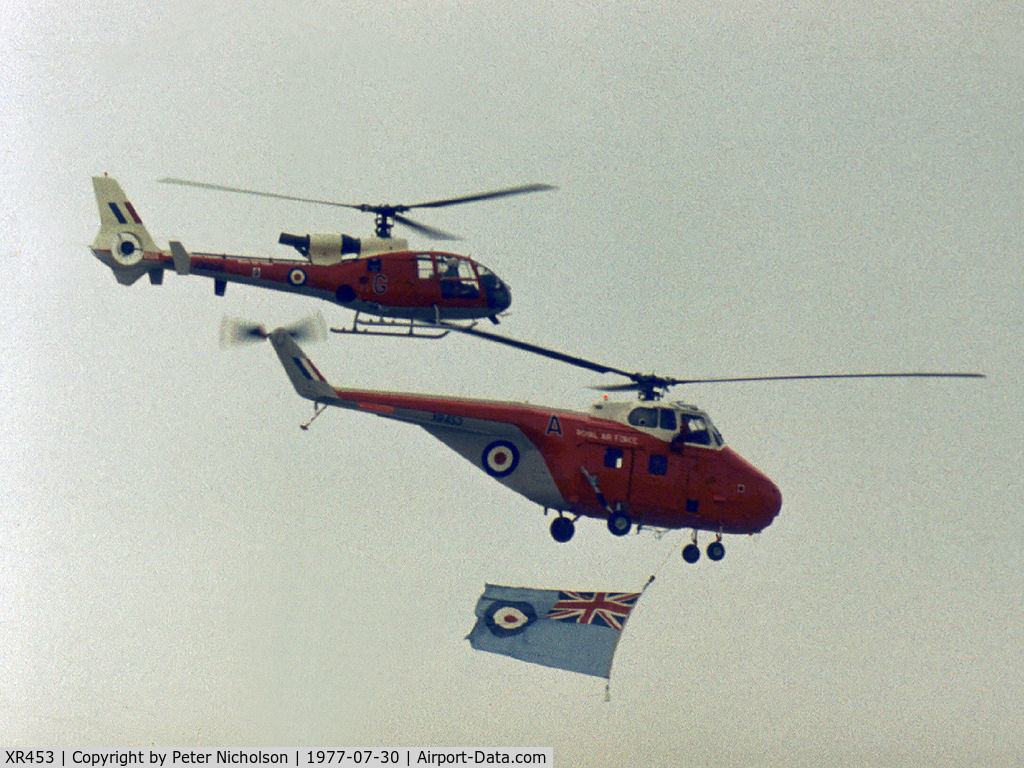 XR453, 1962 Westland Whirlwind HAR.10 C/N WA403, Whirlwind HAR.10 of 2(A) Flying Training School flying the RAF ensign to open the flying display at the 1977 Royal Review at RAF Finningley accompanied by Gazelle HT.3 XW 898