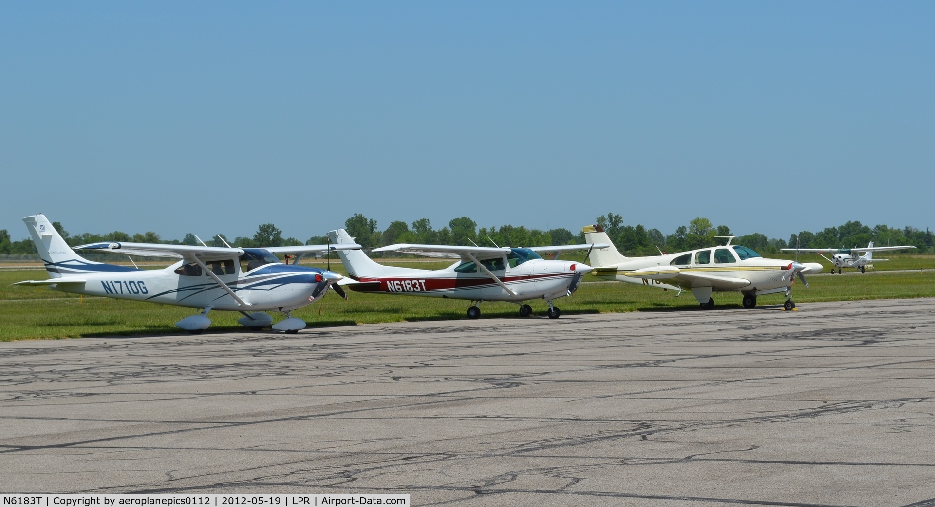 N6183T, Cessna R182 Skylane RG C/N R18201930, N1710G, N6183T and an unidentified aircraft are seen on the tarmac at Lorain County Regional Airport.