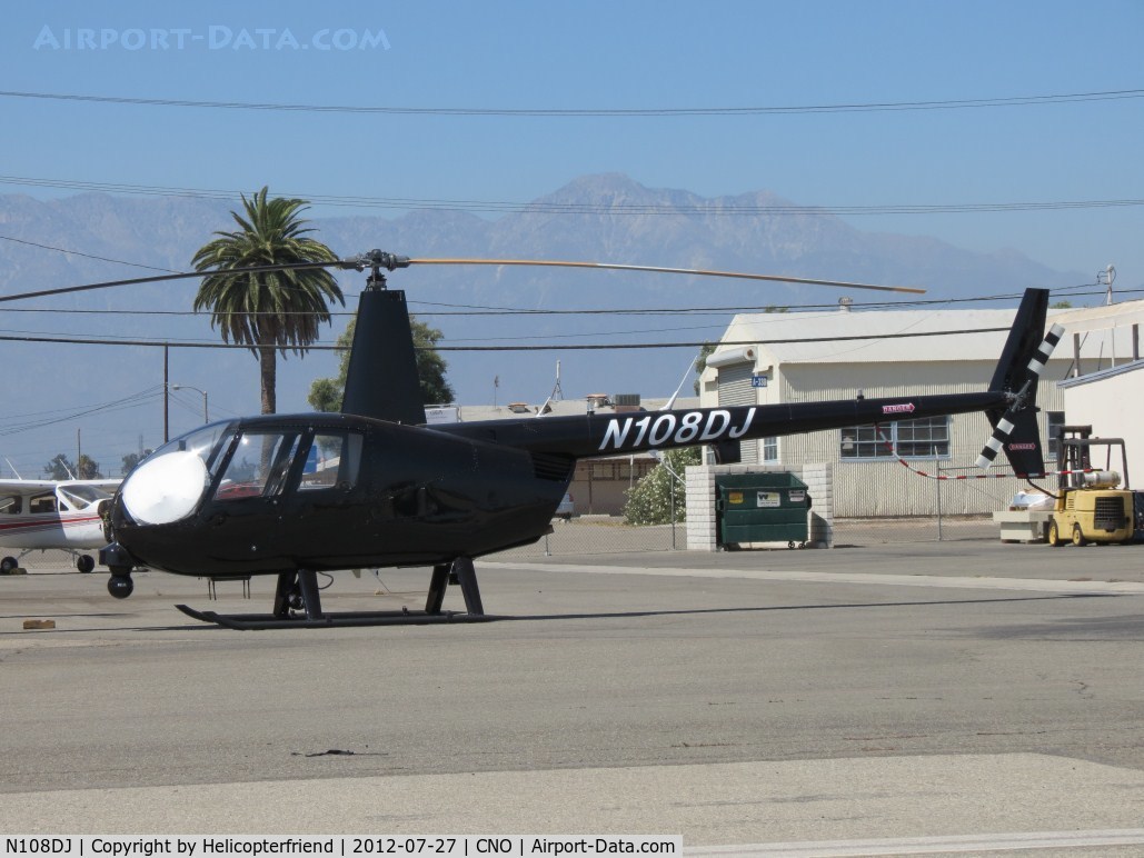 N108DJ, 2001 Robinson R44 C/N 1060, Parked with a sunshade partially blocking the sun