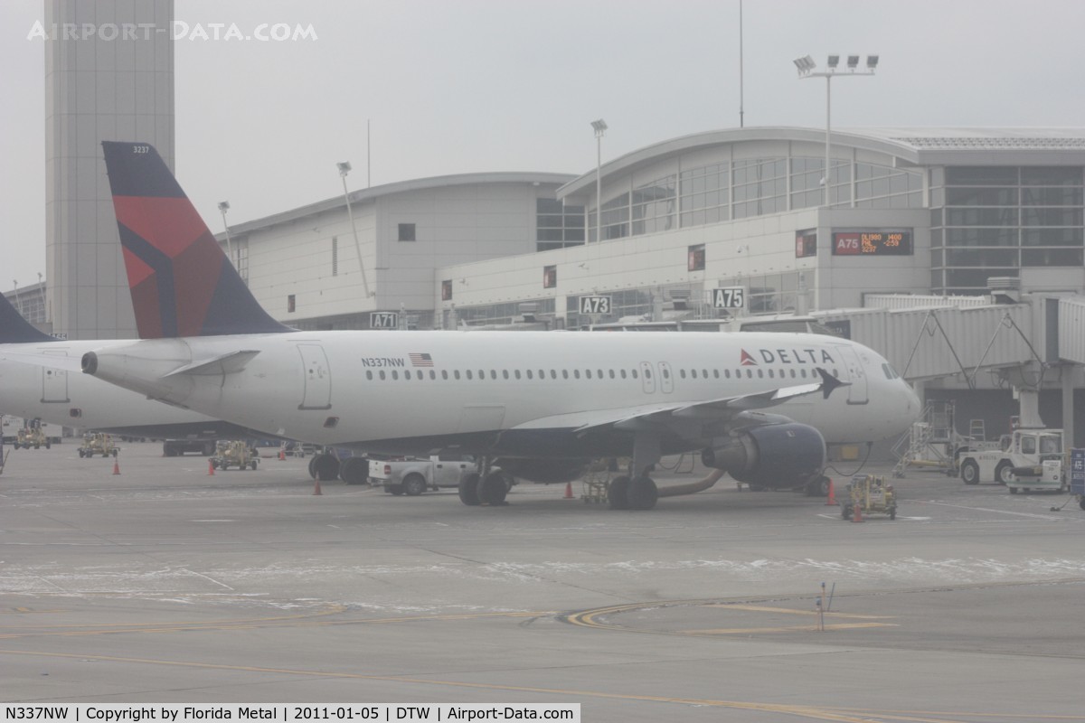 N337NW, 1992 Airbus A320-212 C/N 358, Delta A320 at McNamara Terminal - taken out of the hazed window of a US Airways A319