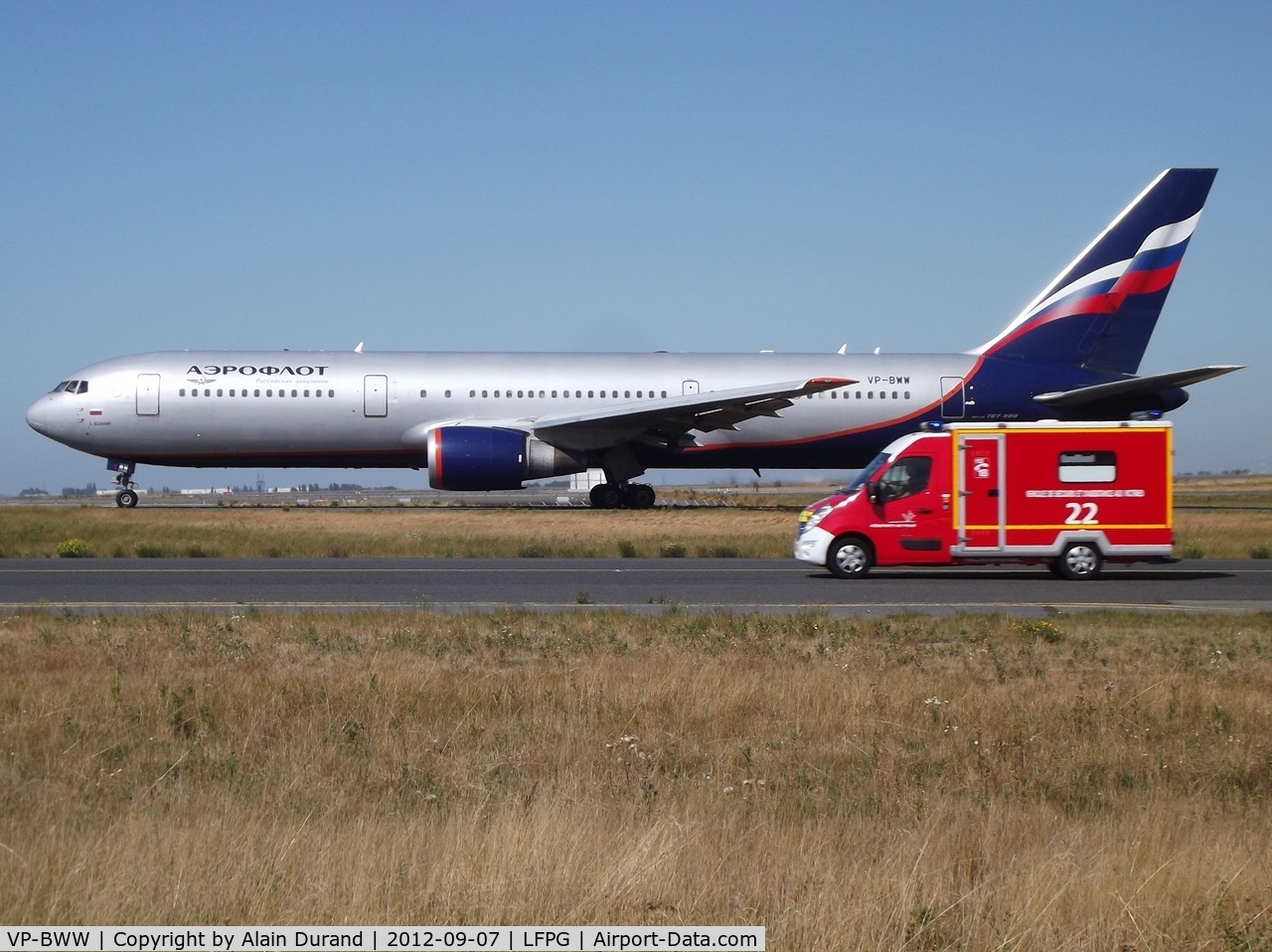 VP-BWW, 1996 Boeing 767-306/ER C/N 27959, Photog's nightmare. The 763 is perfectly side on, but on the same time, a fire brigade ambulance rushes back to base mission accomplished !