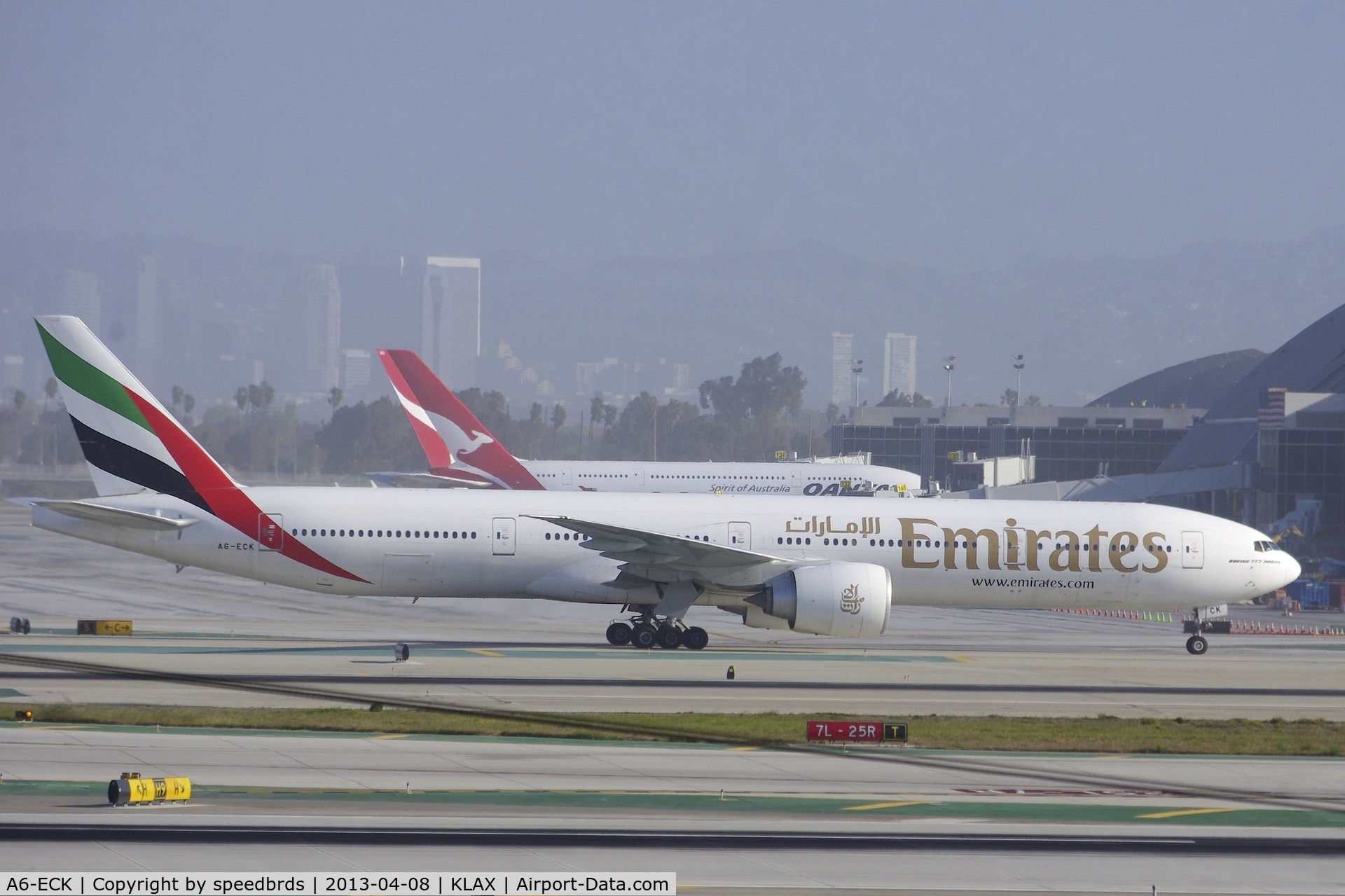 A6-ECK, 2008 Boeing 777-31H/ER C/N 35584, Emirates 77W taxiing to TBIT whilst Qantas Airways A388 is docked at the new TBIT gates.